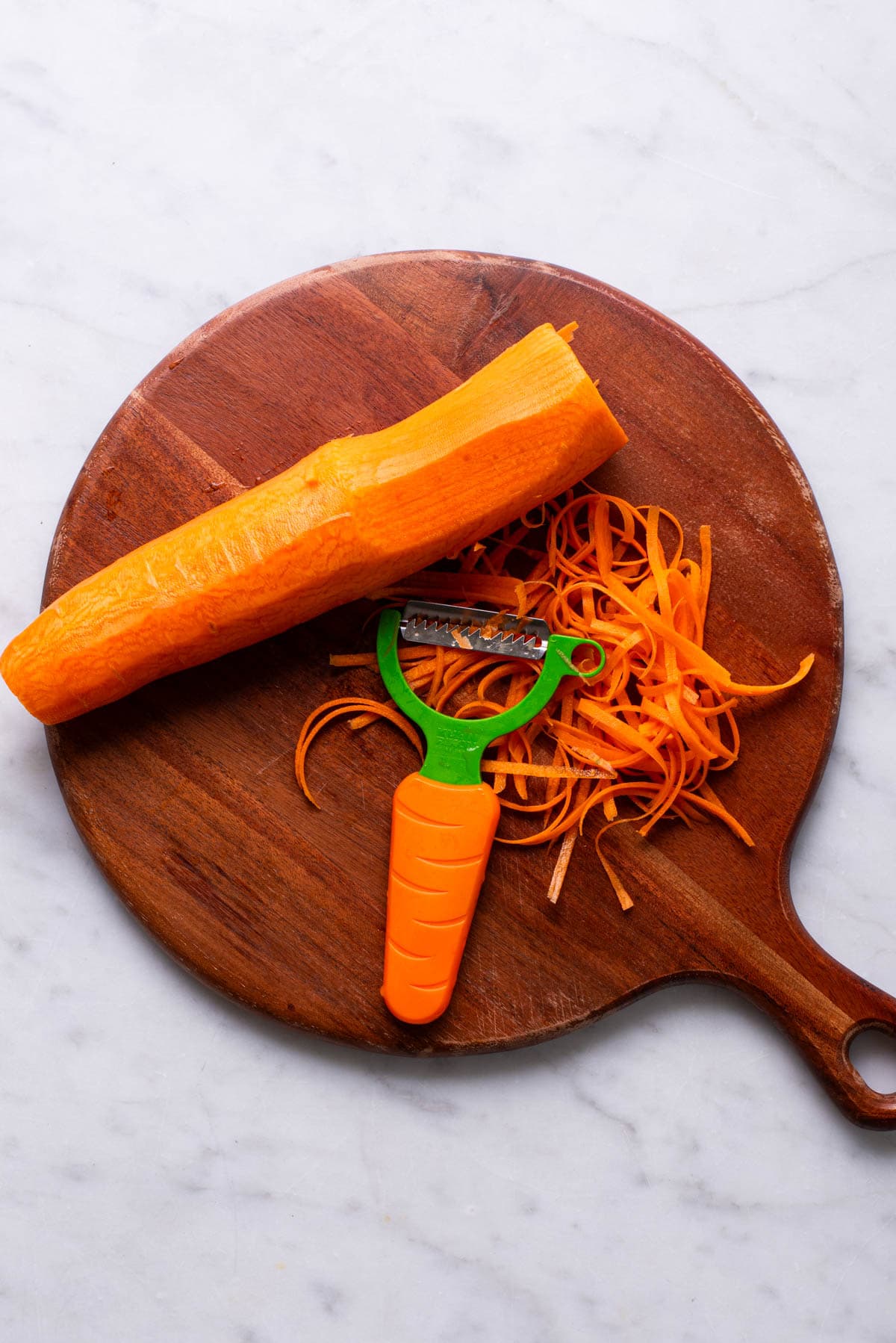 Shredding carrots with a julienne Y-peeler.