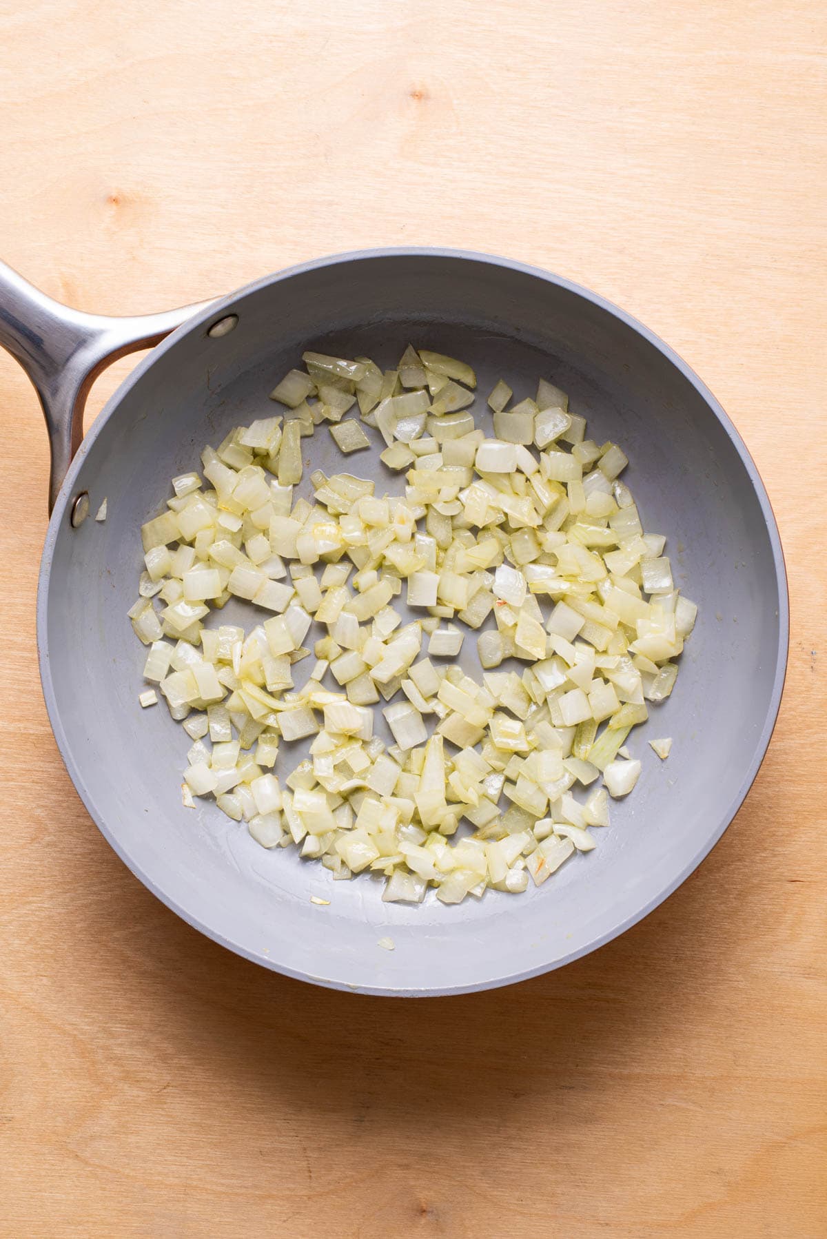 Sauteed diced onion in a skillet.