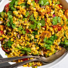 Mexican charred corn salad with cilantro, tomatoes, and avocado.
