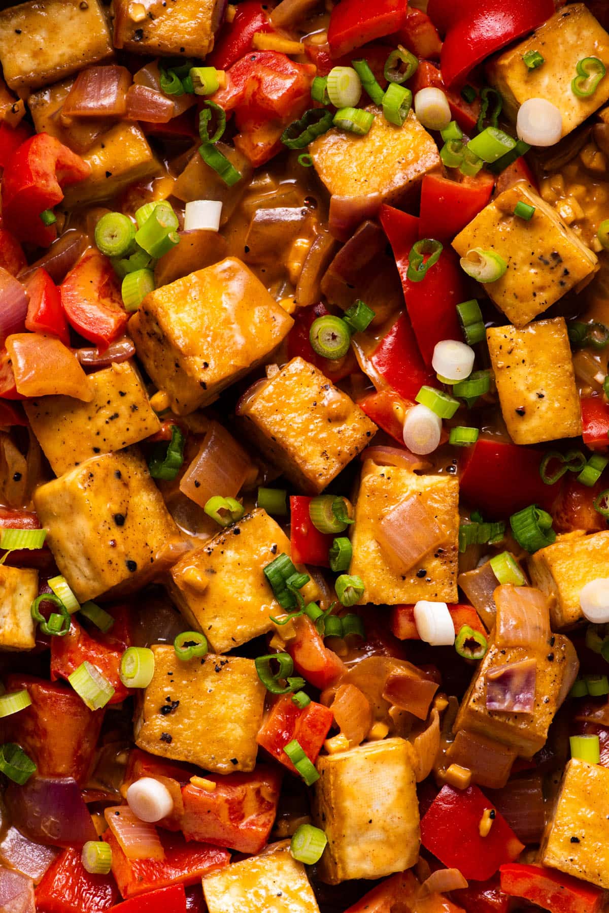 Tofu stir-fry with peanut sauce, peppers, and onions.