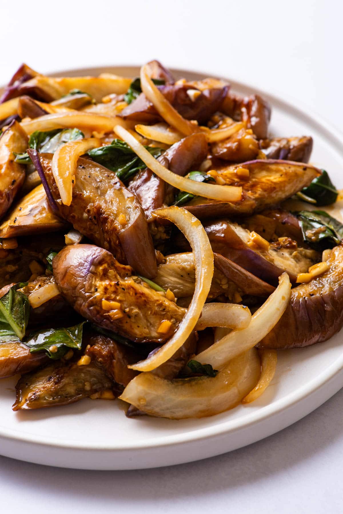 Chinese eggplant stir-fry on a white plate.