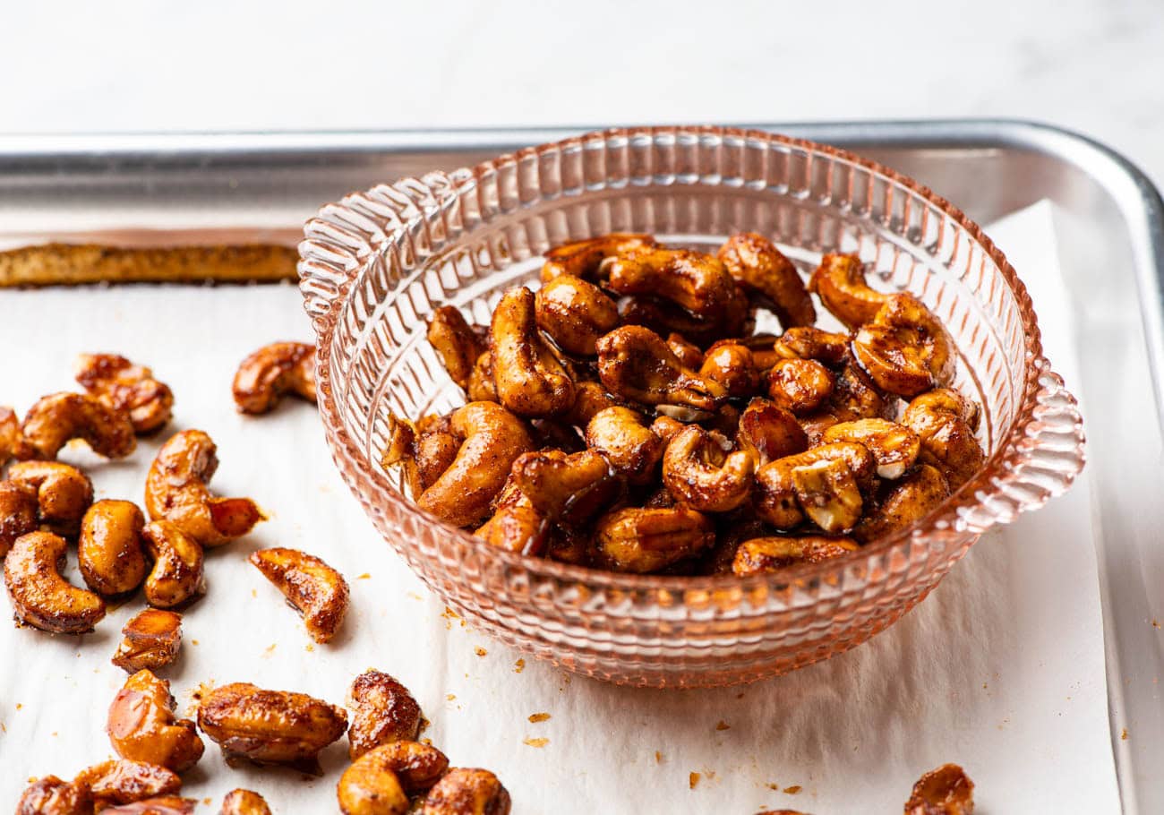 Spiced maple candied cashews in a glass bowl.